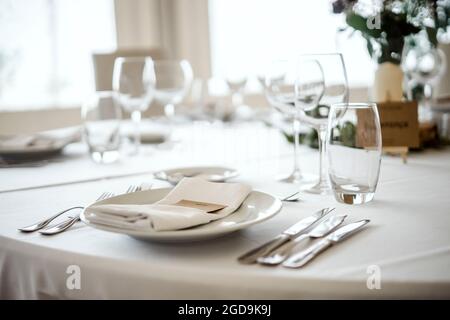 Table setting in a fancy restaurant before wedding reception Stock Photo