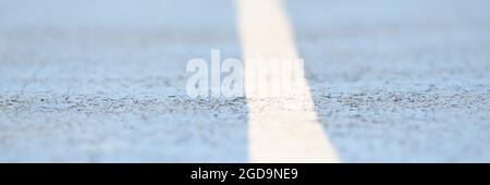 Closeup of white dividing strip on road Stock Photo