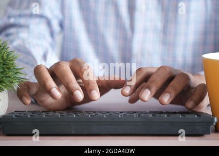 Close up of man hand typing on keyboard  Stock Photo