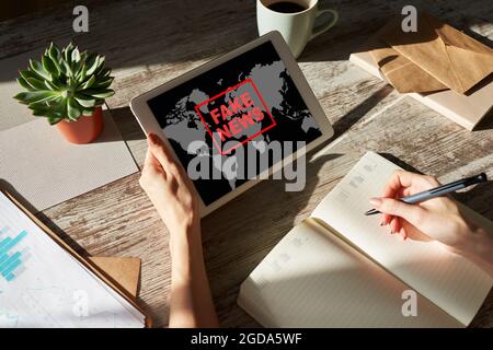 Fake news sign on screen. Propaganda and disinformation. Media and internet concept. Stock Photo