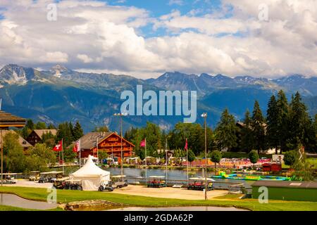 Crans Sur Sierre Golf Course and Water Park and Mountain View in Crans Montana in Valais, Switzerland. Stock Photo