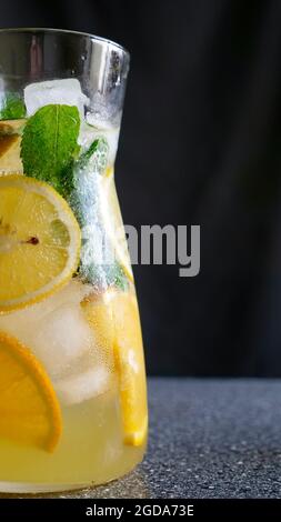 Mojito and Lemonade summer cold drink in a plastic glass with a straw.  Coctail with mint, lemon, lime and ice. Serve at the bar. Beverage closeup  Stock Photo - Alamy