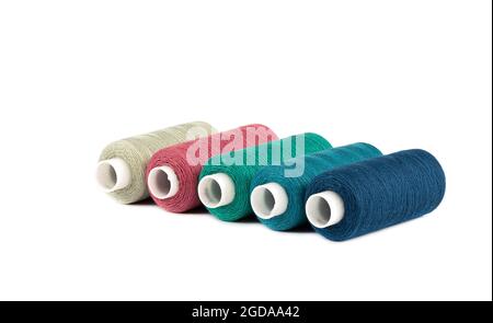 Diagonal from spools of threads of different colors on a white background. Copy space. Stock Photo
