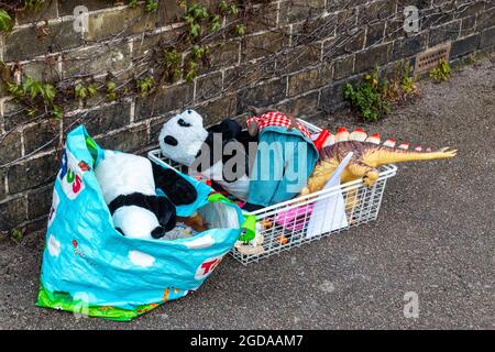 After decluttering a pile of old toys and cuddly pandas are left out on the street for passers by to take. Stock Photo