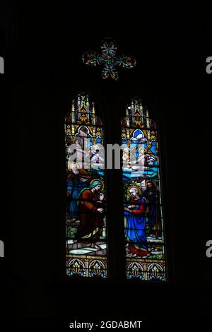 Colorful stained glass windows filled with art from a Catholic church. Salvador Bahia Brazil. Stock Photo