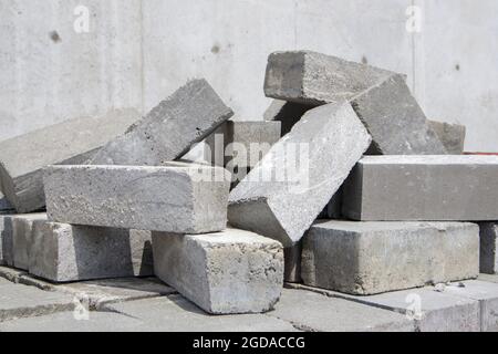 A pile of cement type bricks. Solid brick is used for construction. Lots of loose concrete bricks at the construction site Stock Photo