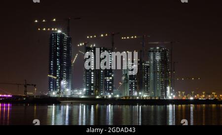 High rise building under construction in the night. dark night shot Stock Photo