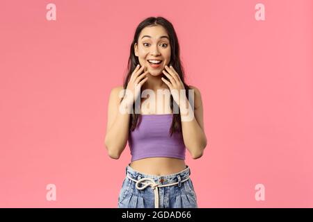 Surprised happy young b-day girl open eyes and see awesome gift friends made, looking camera asonished and cheerful, cant believe dream came true Stock Photo