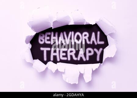 Handwriting text Behavioral Therapy. Business showcase help change potentially selfdestructive behaviors Tear on sheet reveals background behind the Stock Photo