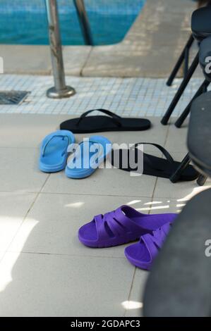POZNAN, POLAND - May 22, 2015: A vertical shot of slippers on tiles in a swimming pool Stock Photo