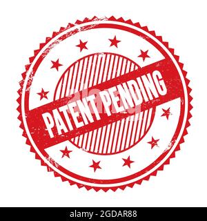 PATENT PENDING text written on red grungy zig zag borders round stamp. Stock Photo
