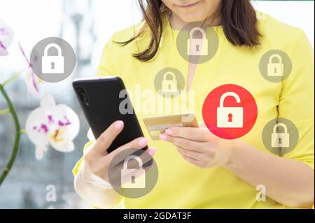 data security when paying online with credit card. Data protection and secure online payments. Closeup view of woman hand using cellphone and laptop. Stock Photo