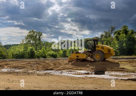Making Roolerl Rink Working on a construction with soil skating rink road roller making new ...
