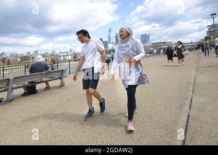 London, England, UK. Young Asian man and woman on the South Bank Stock Photo