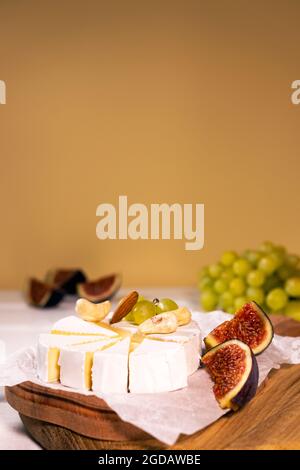 Cheese Brie type Camembert with fig nuts and grape on wooden baord, Healthy Food Concept Stock Photo