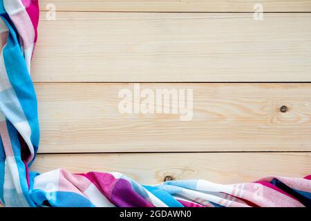 Checkered fabric on wood table background. Stock Photo