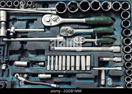 Above view of used greasy old dirty car repair mechanic hand tool set kit vehicle repair and maintencae service. Hardware toolkit with many different Stock Photo