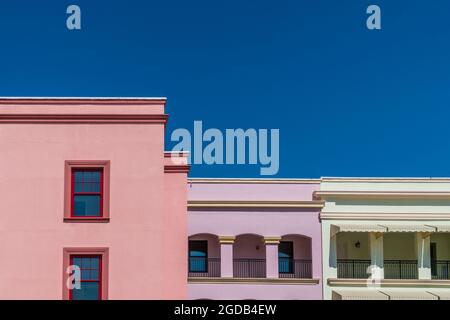 Colorful building facades against deep, bright blue sky Stock Photo