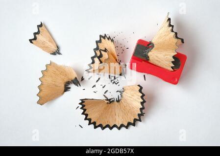 Pencil Shaving, Red Pencil Sharpener on White Background. Stock Photo