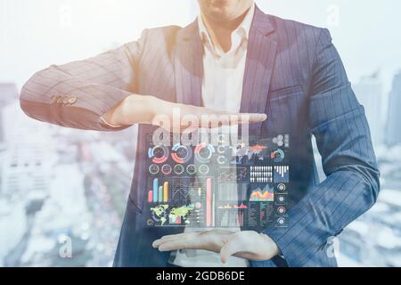 Business man handle information graphics chart for Business Intelligence and Big Data in Marketing Technology for Management concept. Stock Photo
