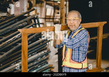 Healthy strong elder old man worker hard working in construction site with protection safety. Stock Photo