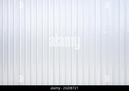 Striped wave silver steel metal sheet industry or construction site wall texture pattern for background. Stock Photo