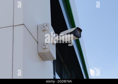 A cctv security camera proteins mounted on the building Stock Photo