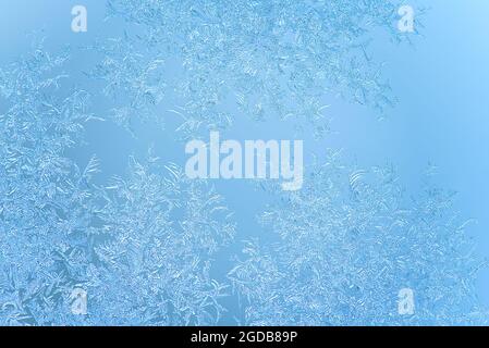 macro shot of natural frost patterns on window in winter day. crispy frost structure Stock Photo