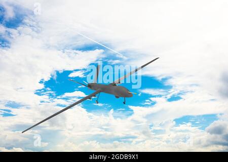 Unmanned military drone on patrol air territory at high altitude Stock Photo