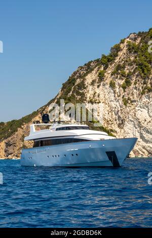 large motor yacht, millionaires lifestyle, large motorboat, wealthy people, big boys toys, motor yacht anchored off greek island, greek island boating Stock Photo