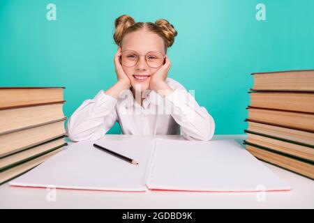 Photo of friendly little girl hands face wear white shirt spectacles isolated on teal background Stock Photo