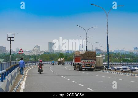 Kolkata, West Bengal, India - 21st June 2020 : View of Kolkata city and traffic on 2nd Hoogly Bridge. Victoria Memorial, a large marble buliding , ico Stock Photo