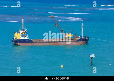 Hopper dredger at sea.Vessel engaged in dredging. Construction Marine offshore works. Dam building, crane, barge, dredger. Stock Photo