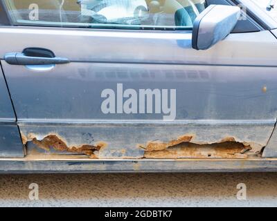 rusted old car doors on city street Stock Photo