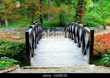 Beautiful wooden vintage bridge over a small river in Sofia park