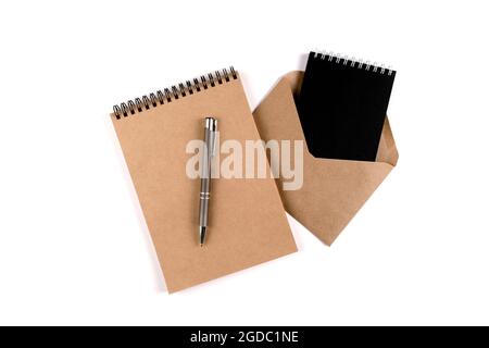 Blank spiral notepads, recycled envelope and automatic pen Stock Photo