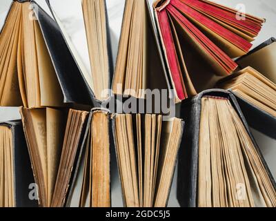 Stack of vintage books lying on the table. Close-up, indoor. Studio photo. Learning and Education Concept Stock Photo