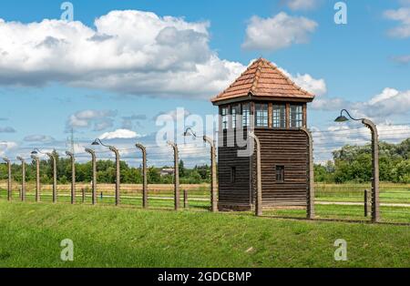 Barbed-wire fence and watch-tower at Auschwitz II-Birkenau concentration camp, Oswiecim, Poland Stock Photo