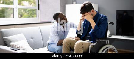 Unhappy Disabled Sad Man In Wheelchair Support Stock Photo