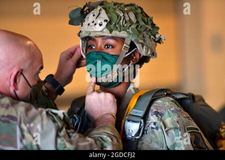 A U.S. Army Paratrooper assigned to the 173rd Airborne Brigade, inspects equipment at Aviano Air Base in preparation for an airborne operation onto Juliet Drop Zone in Pordenone under Covid-19 prevention conditions, Italy, Jan. 13, 2021. The 173rd Airborne Brigade is the U.S. Army Contingency Response Force in Europe, capable of projecting ready forces anywhere in the U.S. European, Africa or Central Commands' areas of responsibility. (U.S. Army photo by Paolo Bovo Stock Photo