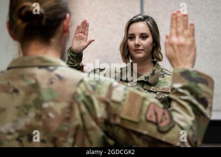 U.S. Air Force Staff Sgt. Jamie Franco, 607th Air Operations Center network defense analyst, recites the oath of enlistment during a change of service ceremony at Osan Air Base, South Korea, Feb. 1, 2021. Jamie and her husband, Frank, both made the jump from the U.S. Air Force to the U.S. Space Force. (U.S. Air Force photo by Staff Sgt. Betty R. Chevalier)
