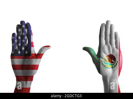 Hands painted in colors of Mexican and USA flags on white background Stock Photo