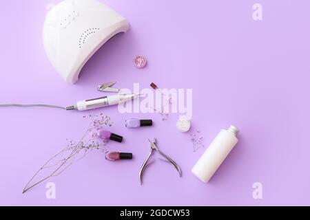 Set of professional tools for manicure and nail polishes on color background Stock Photo