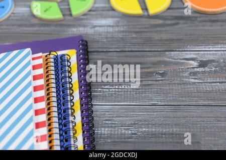 Set of colored notebooks on gray wooden table. Back to school, preschool education. Close up Stock Photo