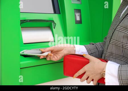 Woman withdrawing money from ATM, closeup Stock Photo