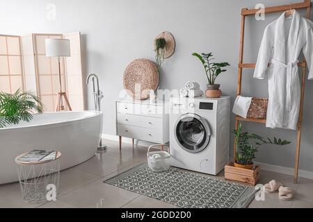 Interior of bathroom with modern washing machine Stock Photo