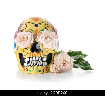 Painted human skull for Mexico's Day of the Dead (El Dia de Muertos) and flowers on white background Stock Photo
