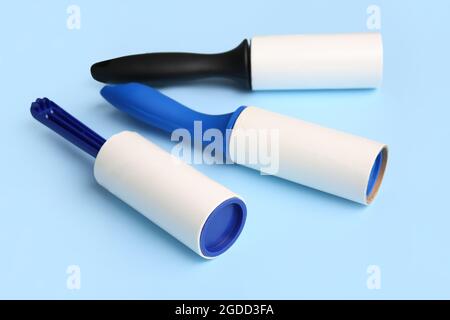 Different lint rollers on color background Stock Photo