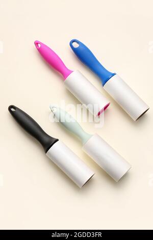 Different lint rollers on color background Stock Photo