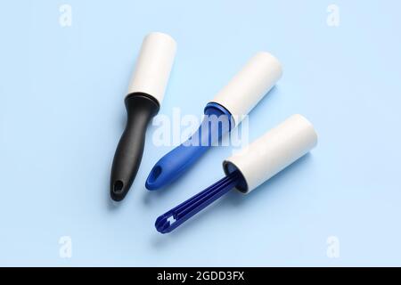 Different lint rollers on color background Stock Photo